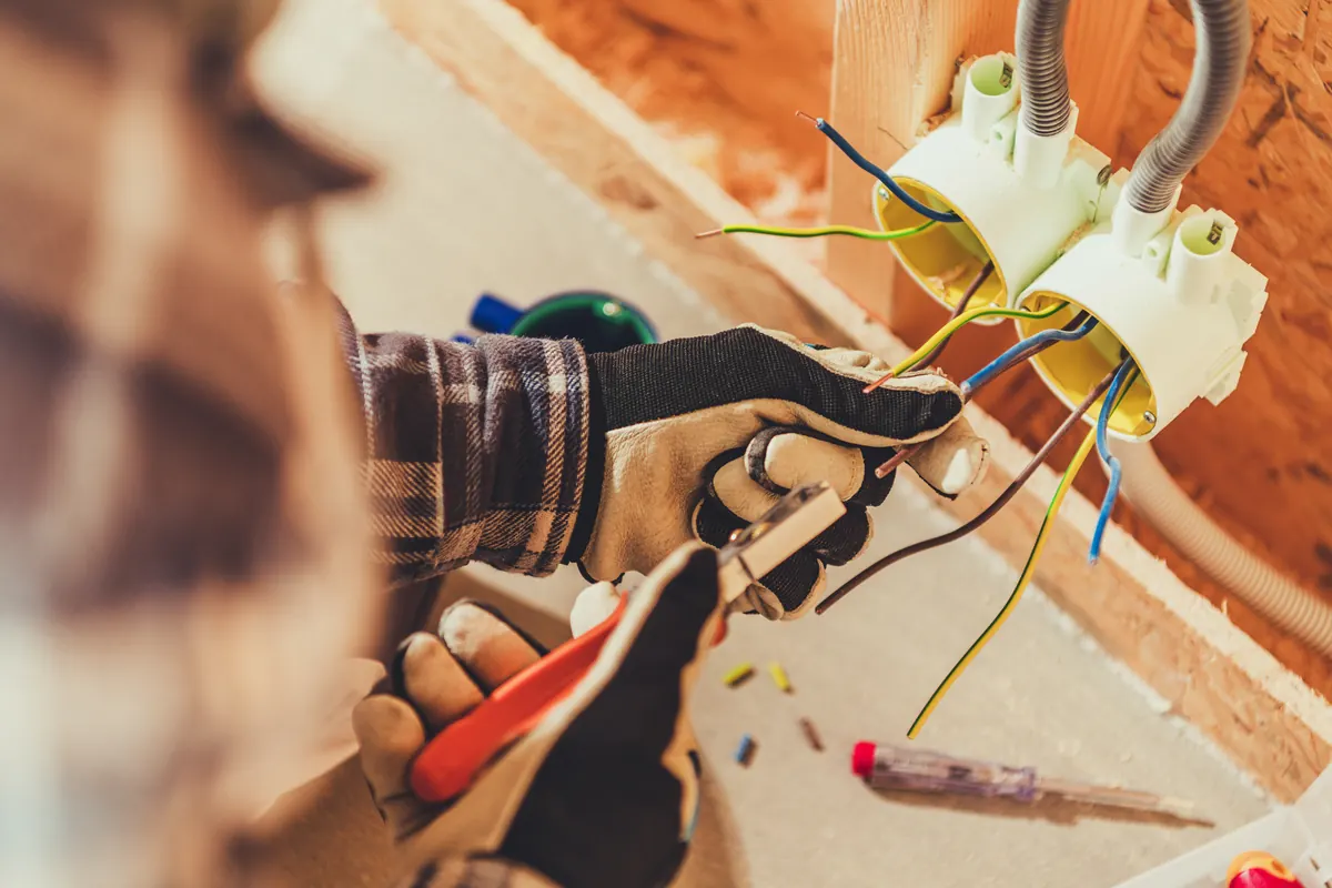 Hands wiring an electrical box during an installation