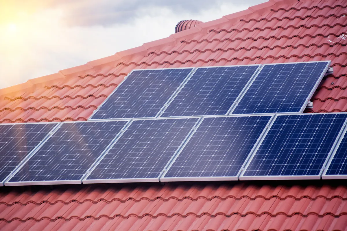 Two-storey house with solar panels on its roof