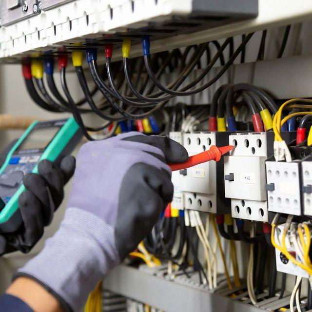 Electrician testing electrical panel